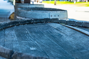 The lids of three wooden barrels standing near the building
