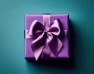 Top view of a purple gift box wrapped with a shiny satin ribbon bow, placed on a teal surface conveying elegance and celebration