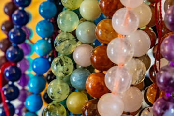 Colorful beads and bracelets made of different stones and minerals
