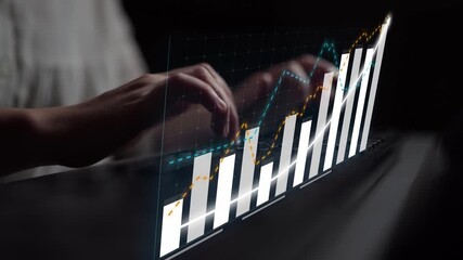 A businesswoman engages with a transparent interactive display showing financial growth, emphasizing data analysis and modern technology for successful decision-making. Copula - Powered by Adobe