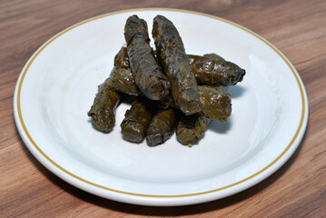 Stuffed grape leaves Turkish appetizer plate on table in restaurant