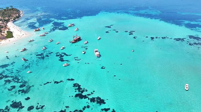 4k drone video of Garip and Kalem islands with turquoise sea and coral reefs in Bademli. Dikili, a district of Izmir famous for its turquoise sea in Turkiye.