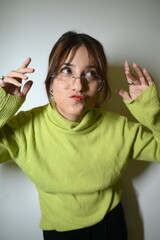 Young woman in glasses. Stylish trendy posing in glasses.    Funny emotions.