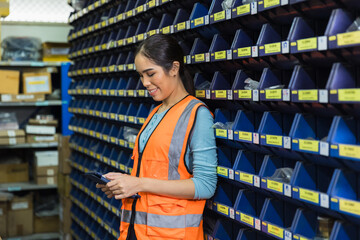 Happy woman worker engineer technician staff work in factory products inventory parts storage room
