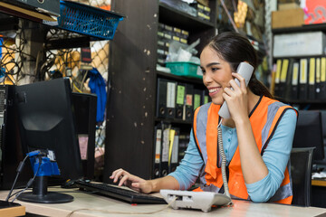 Happy woman engineer technician staff calling order in factory products inventory accountant room