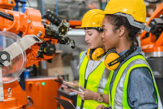 robotic engineer training, technician work in factory industry robot welding arm machine control