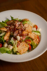 Classic Caesar Salad with Grilled Chicken and Bacon. Fresh romaine lettuce, croutons, Parmesan cheese, and creamy Caesar dressing, topped with tender grilled chicken and crispy bacon bits.