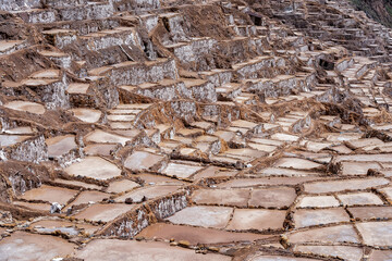 Salt ponds of Maras down a terraced hillside in the Sacred Valley of Peru.