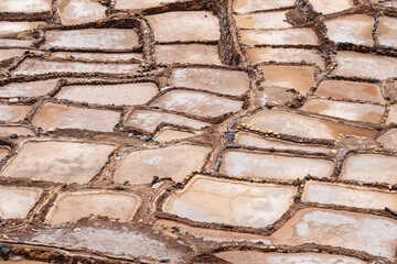 Salt ponds of Maras down a terraced hillside in the Sacred Valley of Peru.