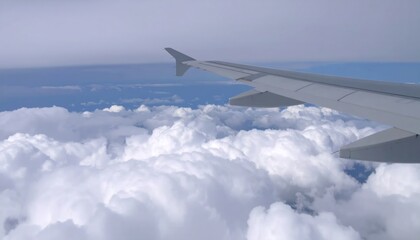 Fototapeta premium Airplane wing view flying above clouds with travel, and sky.