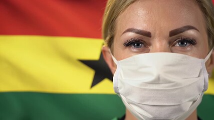 Close Up Portrait of Blond Woman in Surgical Mask with Ghana Flag Backdrop - Powered by Adobe