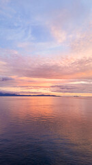 Fototapeta premium Golden sunset over Kri Island in Raja Ampat, West Papua, Indonesia, symbol of romance, relaxation and wanderlust.