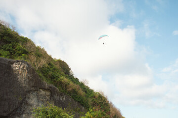 Adventure Paragliding Against Blue Sky in Bali Indonesia