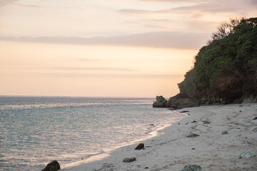 Bali, Indonesia - August 2025: Sunset on Tropical Beach with Rocky Cliff in Bali Indonesia