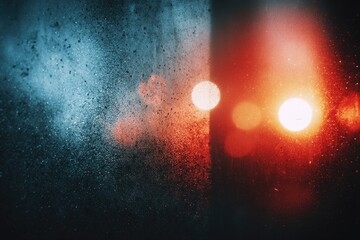 Night lights through a misty window