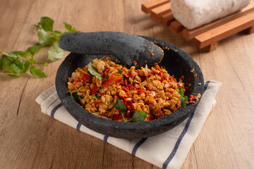 Sambal Tempe served on cobek. Tempe is a traditional food from Indonesia made from soybean. Perfect for recipes, articles or any cooking content.