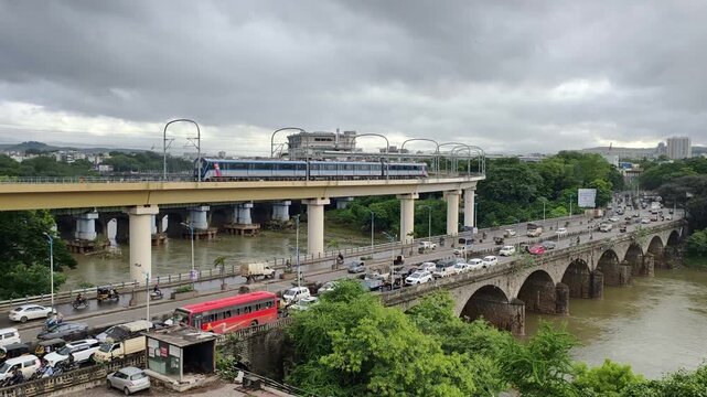 22 August 2025, Pune, Maharashtra, India, Metro runs on an overhead track, Vehicle moves along the Pune metro rail road near Sangam Bridge, now the Indian urban mass transit metro railway system.