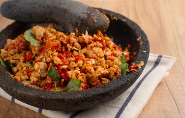 Sambal Tempe served on cobek. Tempe is a traditional food from Indonesia made from soybean. Perfect for recipes, articles or any cooking content.