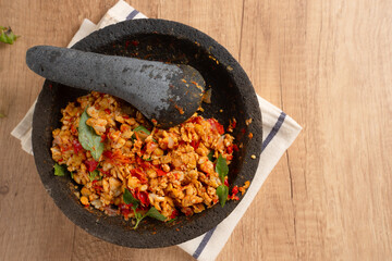 Sambal Tempe served on cobek. Tempe is a traditional food from Indonesia made from soybean. Perfect for recipes, articles or any cooking content.