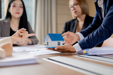 Multiracial professionals in office meeting, businessmen and businesswomen brainstorming ideas, teamwork and leadership fostering cooperation and success.

