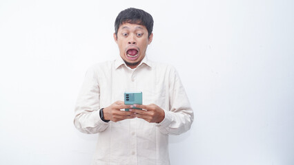 Asian man make a shock face expression when looking to phone that he hold
