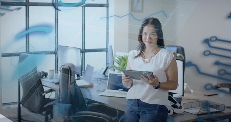 Office woman tapping tablet revealing real-time business analytics overlays, smiling confidently - Powered by Adobe