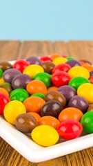 Colorful candy on a white plate