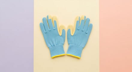 Obraz premium A pair of blue and yellow gardening gloves laid flat on a neutral background.