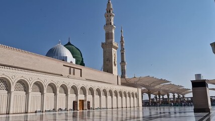 Pan up of green and silver dome of Nabawi mosque in Medina, Saudi Arabia. - Powered by Adobe
