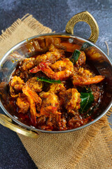 Authentic Kerala style prawn ghee roast, spicy South Indian seafood delicacy made with fresh prawns, clarified butter, roasted spices and curry leaves, traditional Malabar coastal dish