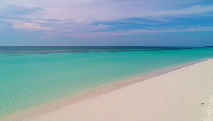 Fototapeta premium Serene tropical beach with pristine white sand and turquoise water under a partly cloudy sky.