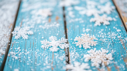 Fototapeta premium Blue wooden background adorned with white frosted snowflakes. Perfect winter texture for seasonal designs.