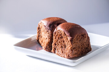 Chocolate bread squares placed on a white plate for breakfast.