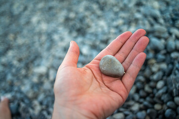 Smooth pebble stones scattered along a coastal shoreline, highlighting natural textures and seaside beauty.