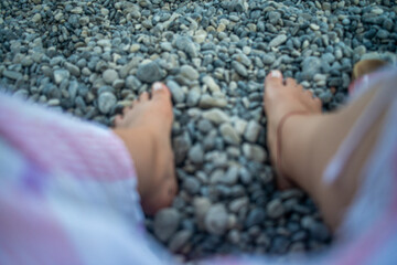 Smooth pebble stones scattered along a coastal shoreline, highlighting natural textures and seaside beauty.