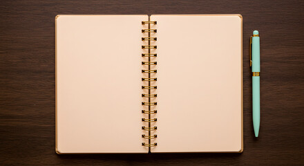An open blank notebook alongside a stylish pastel pen presents a clean and inviting workspace aesthetic on a dark