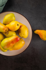 ripe green pears on dark background.