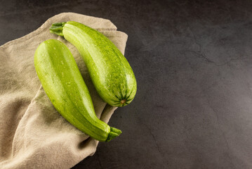 Fresh young zucchini on Dark Table - Summer Harvest