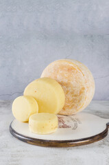 Assorted tasty cheese of different kinds and sizes on table.