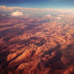 Aerial view of vast, terracotta-colored desert mountains