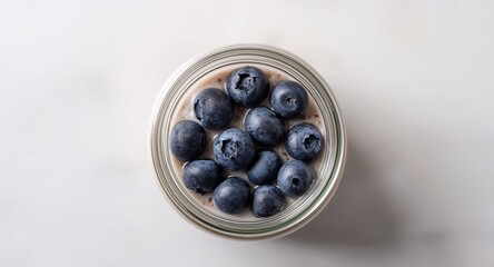 Jar of Overnight Oats with Fresh Blueberries, Healthy Breakfast Dessert, Top View.