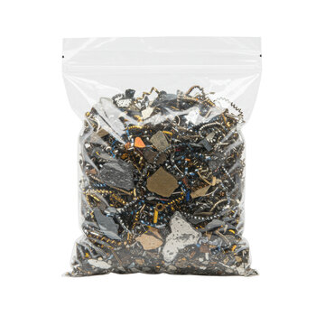 Transparent plastic bag with gleaming, irregular metal shavings for orgonite making, on a transparent, shadowless studio background, high angle. Concept for raw material product display