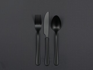 Cutlery Arrangement on Dark Textured Surface, Focused Composition, Minimalist Style.