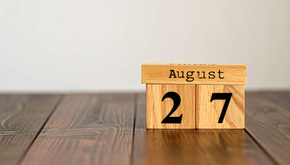 Wooden cubes with text AUGUST 27. Date, schedule or reminder. Minimalistic calendar design.