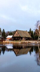Naklejka premium Wooden House Reflection, Winter Village Pond