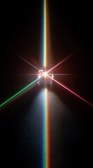 Light refracts through a crystal creating vibrant colors against a dark background