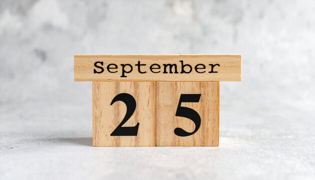 Wooden cubes with text SEPTEMBER 25. Date, schedule or reminder. Minimalistic calendar design