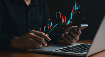 fiancial Trader Analyzing Market Data on Laptop and Phone