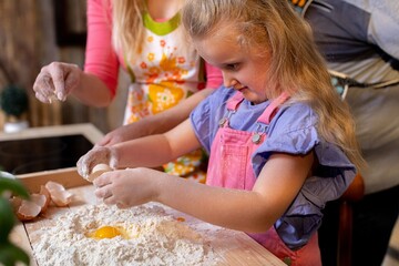 A Child is Joyfully Enjoying Baking Together with Adults in a Cozy and Inviting Kitchen Space