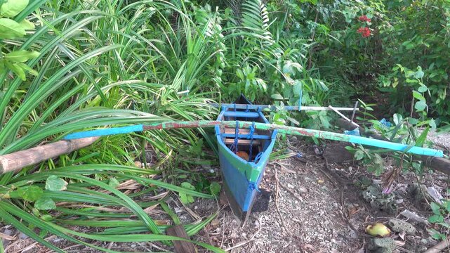 A small boat with counterweights used by Indonesians to fish in coastal waters. Sulawesi, Bunaken island